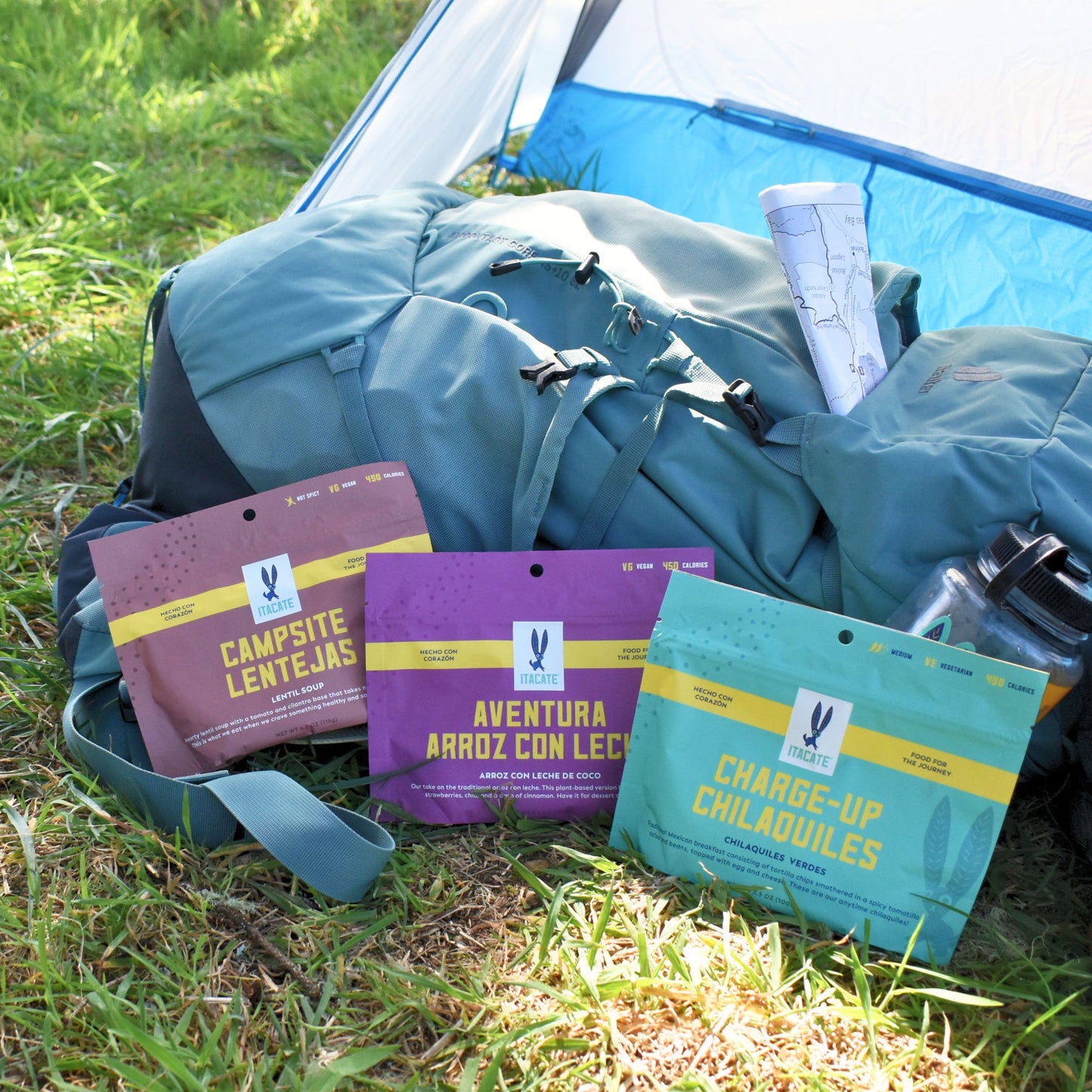 
                  
                    3 meal bundle on the floor laying on a hiking backpack in front of a tent
                  
                