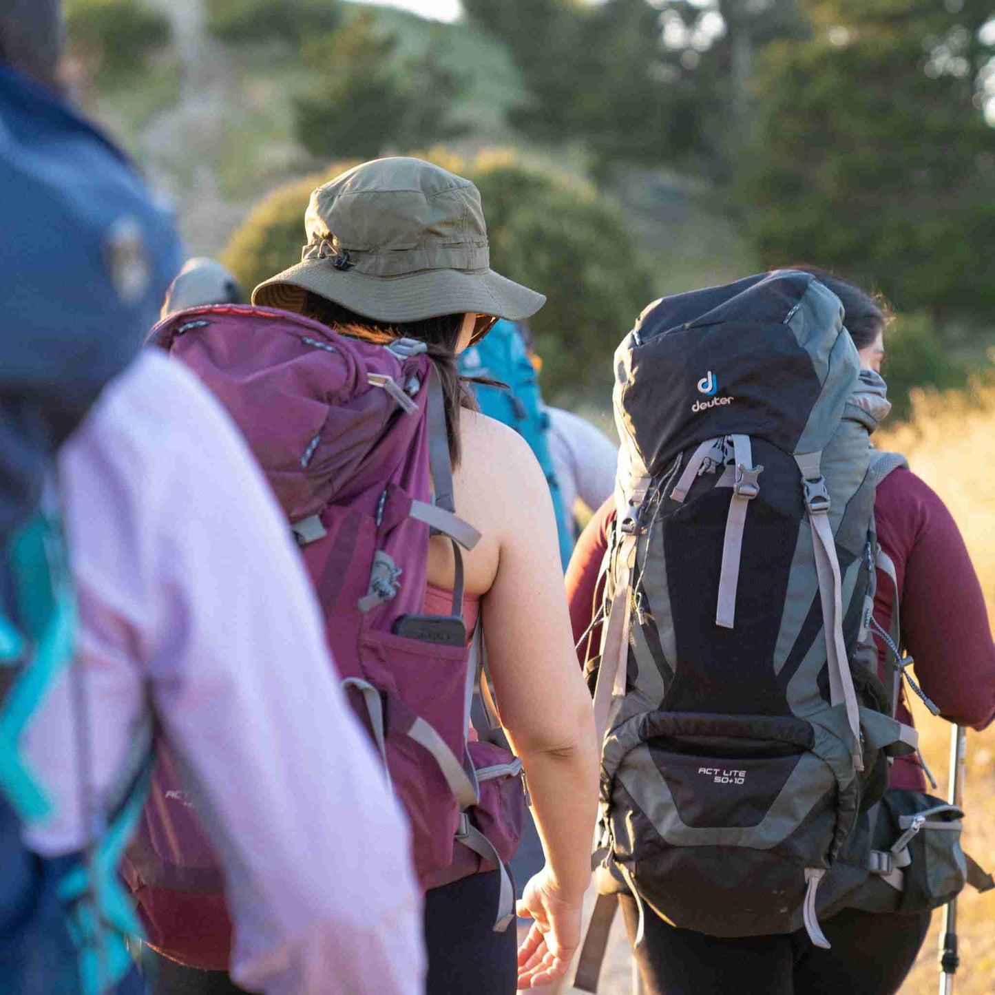 
                  
                    a group of women backpackers with gear are walking towards their destination
                  
                